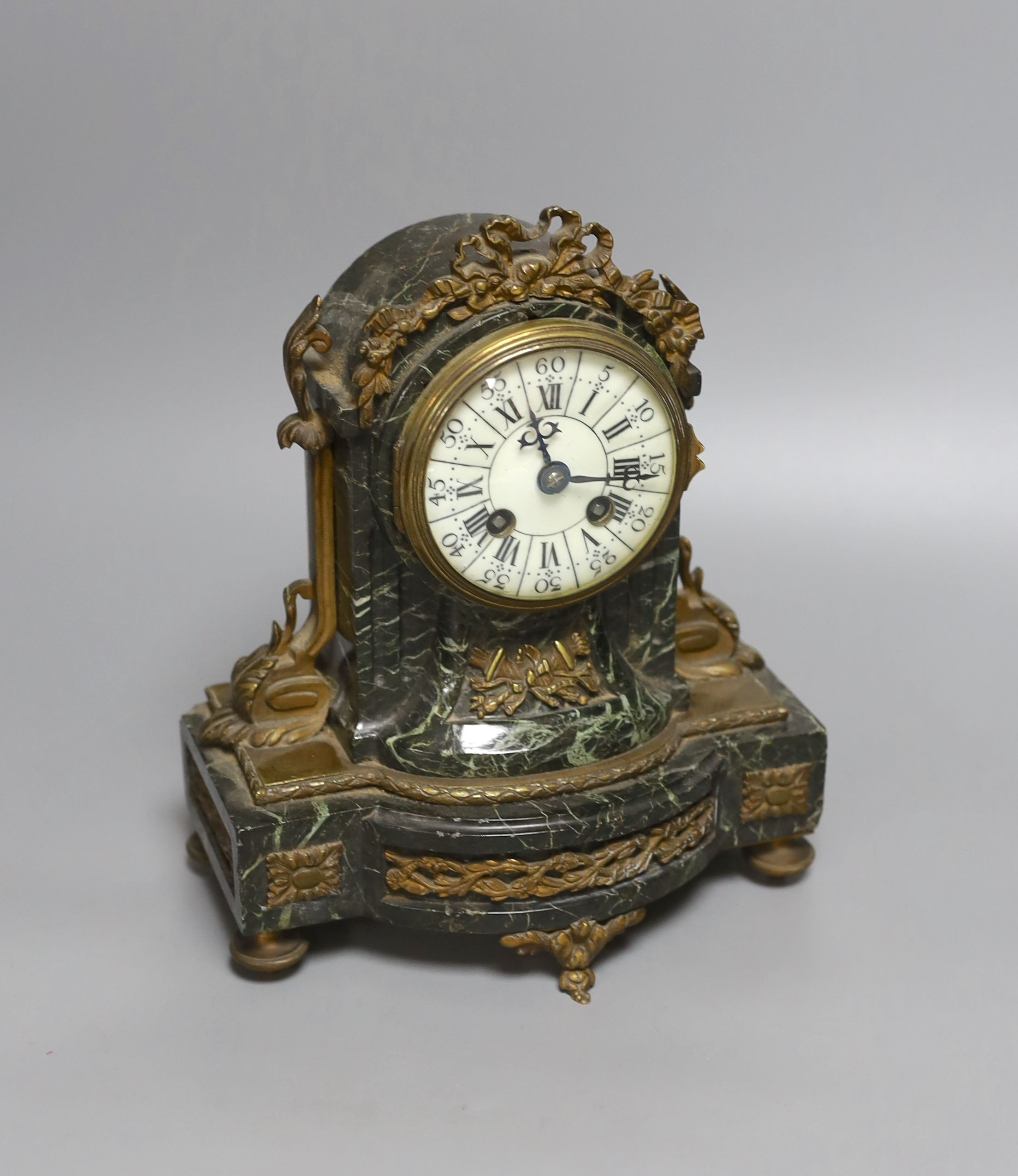 A 19th century French gilt metal mounted serpentine mantel clock, 23cms high.